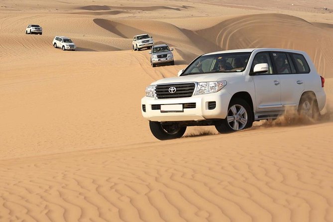 Best Dubai Desert Safari with Buffet Dinner,Sand Boarding & Shows - Sandboarding on the Lahbab slopes