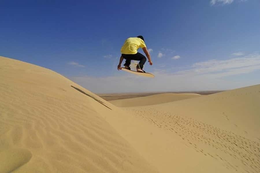 Desert Safari, Quad Bike, Camel Ride, Falcon & Sandboarding - Dune bashing across the open sand