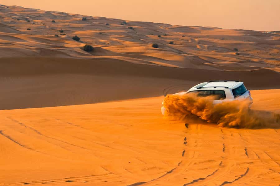 Doha: Desert Safari with Quad Bike, Sandboard & Camel Ride - Sandboarding on the soft dunes