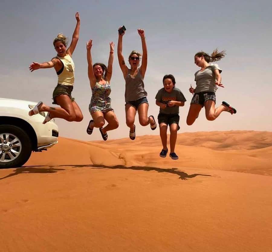 Doha: Inland Sea Desert Safari with Sunset & Sunrise Views - Khor Al Adaid: sandboarding beside the water