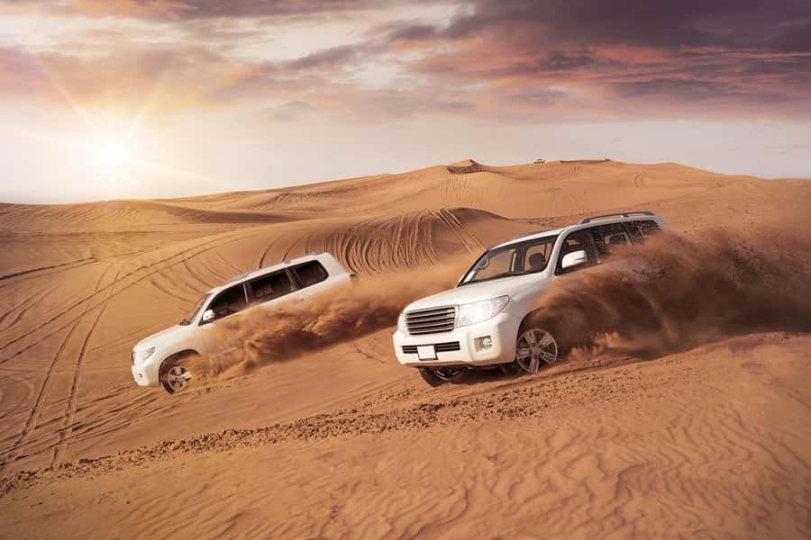 Dubai: Desert Safari, Camel Ride, and BBQ Dinner - Sunset over the Dubai desert
