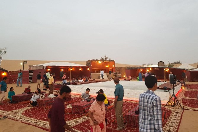 Dubai Desert Safari with Quad Bike, sandboarding, live show & BBQ - Sandboarding, camel riding, and the camp welcome