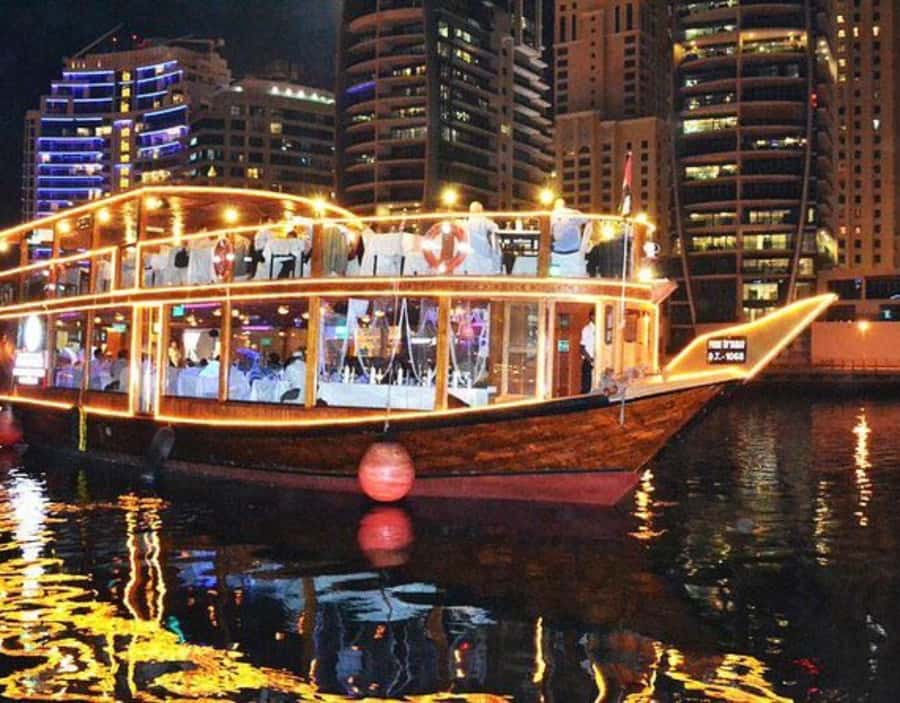 Dubai: Dhow Dinner Cruise on Creek or Marina with Live Shows - A traditional dhow with a modern Dubai view