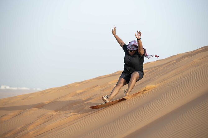 Dubai Half-day Red Dunes bashing with Sandboarding, Camel &Falcon - Sandboarding after the vehicle ride