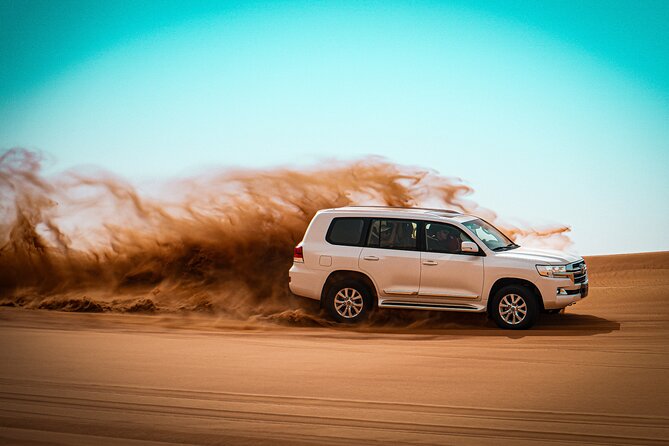 Dubai Morning Desert Safari with Quad Biking & More Activities - Sandboarding on red sand
