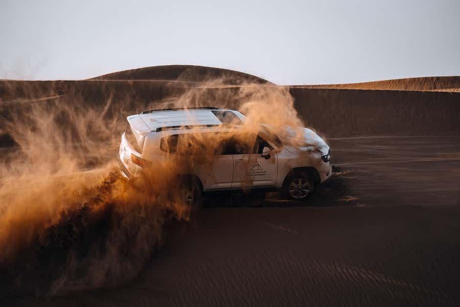 Dubai: Premium Desert Safari, Camel Ride, BBQ & Sandboarding - Leaving Dubai for the Fort Lisaili dunes