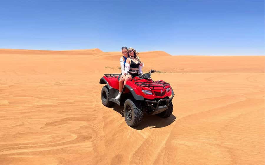Dubai: Quad Bike, Dune Buggy, and Sandboarding Experience - Red dunes, roaring engines, and a short camel ride