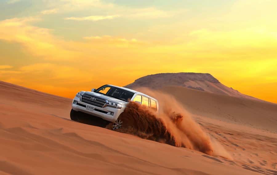 Dubai: Red Dune Desert Safari, Quad Bike, Camels, and BBQ - From Dubai hotel pickup to the red dunes