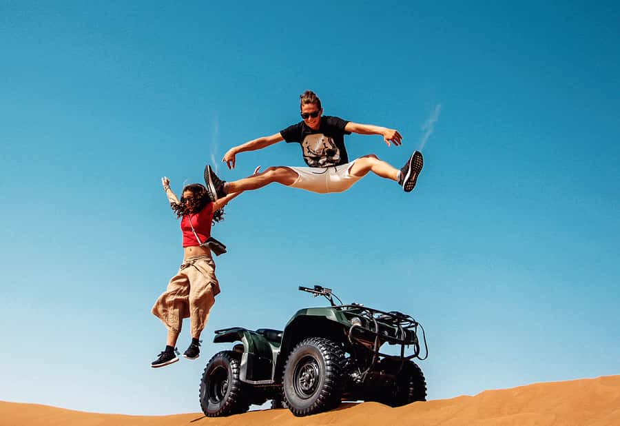 Dubai: Red Dunes Quad Bike with Sandboarding, Camels and BBQ - Sandboarding and photo stops on the dunes