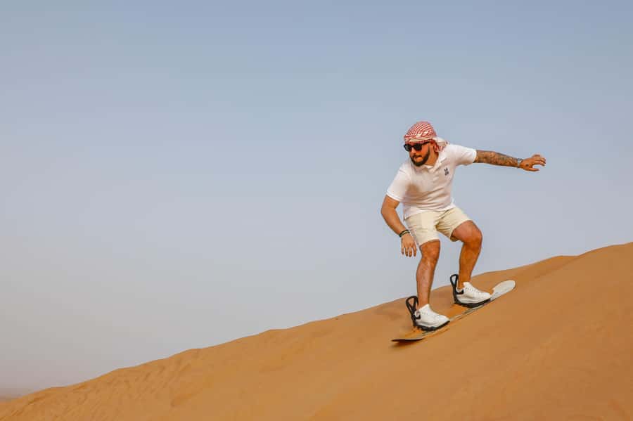Dubai: Red Dunes Quad Bike with Sandboarding, Camels and BBQ - Quad biking across Lahbab’s red sand