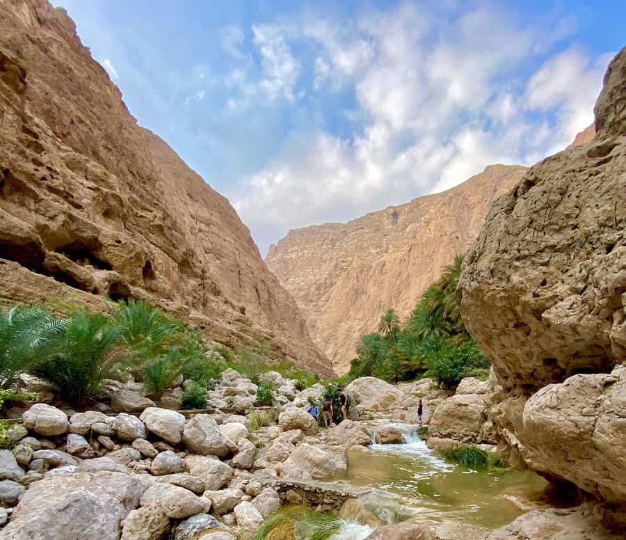 From Muscat: Wadi Shab & Bimmah Sinkhole Full-Day Tour - Crossing the wadi and starting the canyon walk