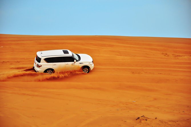 Half Day Desert Safari || Sand Boarding || Camel Ride || Inland Sea Visit || - Sandboarding on the dunes